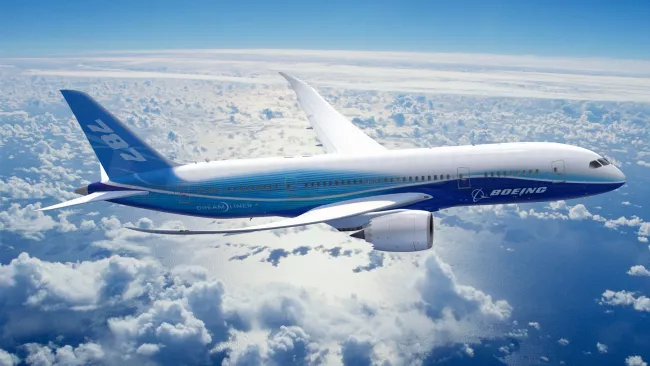 A boing 787 flying through clouds