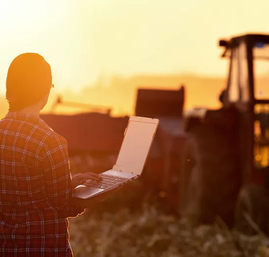 smart farming woman standing in front of a tractor