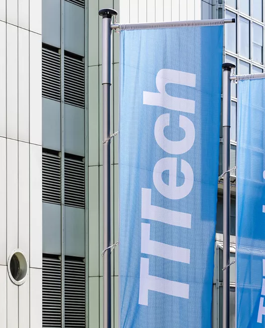 TTTech flag in front of building